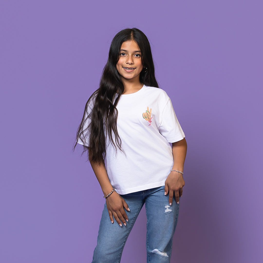 Girl wearing white tee with a peace sign