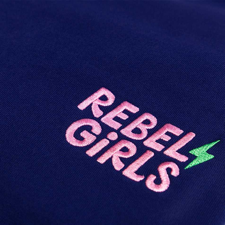 Navy blue cloth with "Stay Rebel" text in pink and green