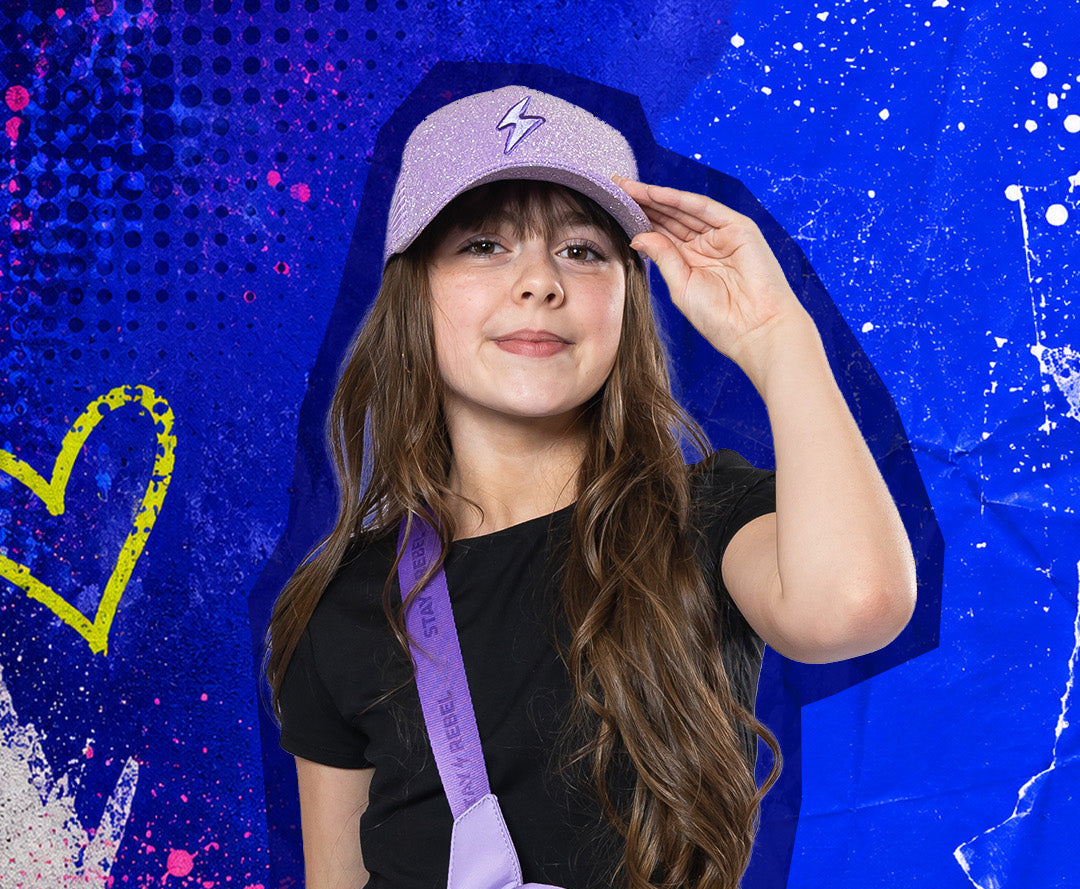 Young girl wearing a purple cap and carrying a matching purple bag against a colorful, abstract background.